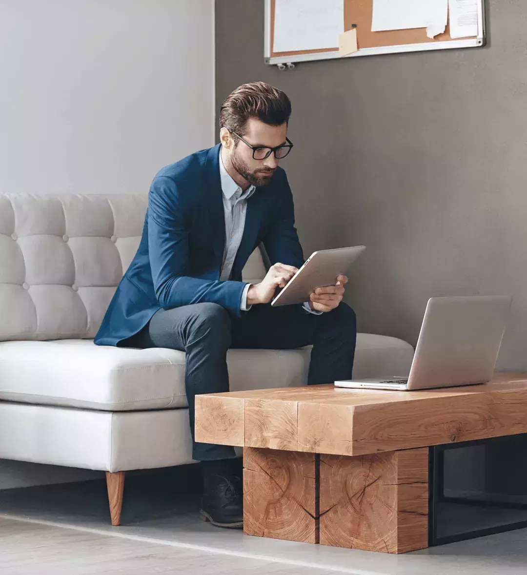 Business person looking at tablet hero square